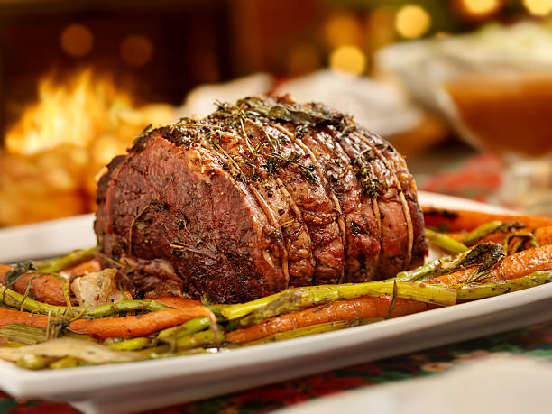 Christmas Roast Beef Dinner Prime Rib Roast Beef Dinner, With Yorkshire Pudding,Roasted Carrots, Asparagus and Fresh Herbs  -Photographed on Hasselblad H3D2-39mb Camera roast beef photos stock pictures, royalty-free photos & images