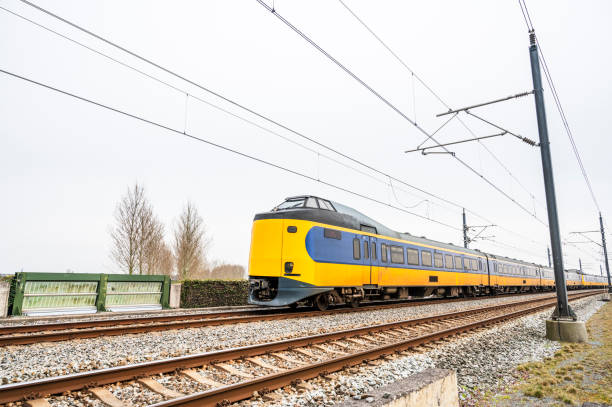 istock Train of the Dutch railways driving through a rural landscape during springtime 1677844501