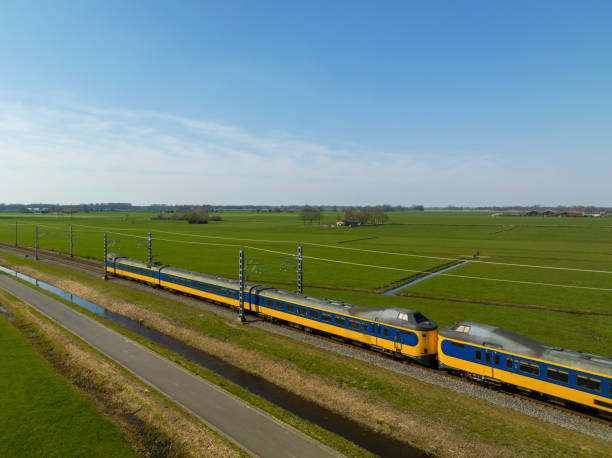 istock Train of the Dutch Railways driving through a rural landscape during springtime 1677844603
