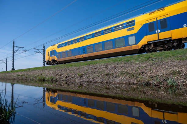 istock Train of the Dutch Railways driving through a rural landscape during springtime 1677845621