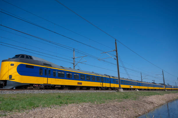istock Train of the Dutch Railways driving through a rural landscape during springtime 1677846682