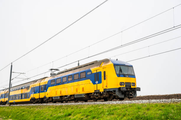 istock Train of the Dutch railways driving through a rural landscape during springtime 1677846697