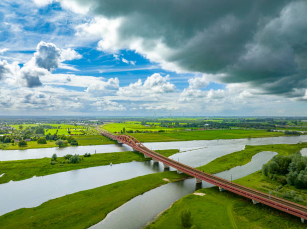 Hanzeboog train bridge over the river IJssel near the city of Zwolle in Overijssel, The Netherlands. Aerial drone point of view.