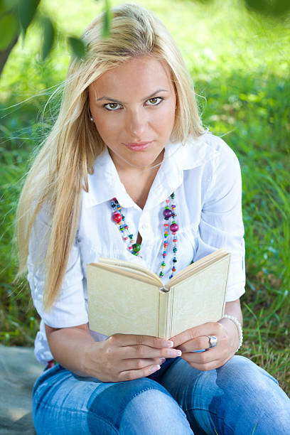 istock Girl reading book in the park 167785543