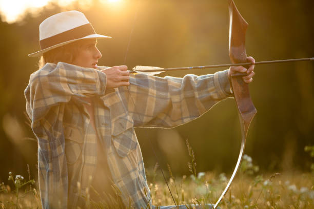 istock Young man firing bow and arrow 167785727