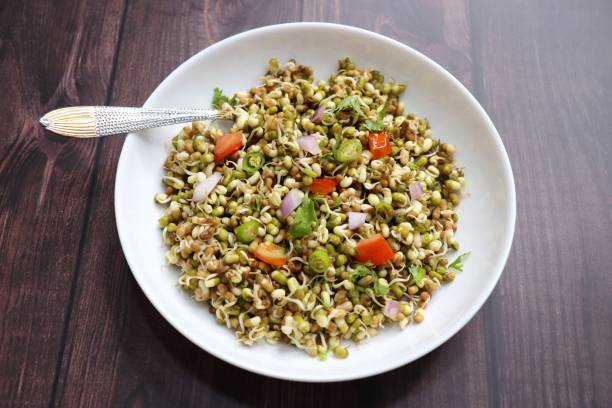 Sprouted moong beans. Protine rich salad. Healthy snack items. Sprouted Lentil Salad. Mixed with Onion, tomatoes, green chili and coriander. Copy space. Sprout Bhel.