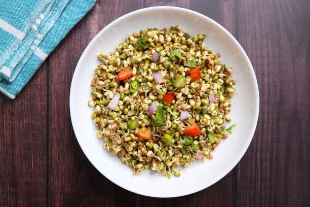 istock Sprouted moong beans. Protine rich salad. Healthy snack items. Sprouted Lentil Salad. Mixed with Onion, tomatoes, green chili and coriander. Copy space. Sprout Bhel. 1677867425