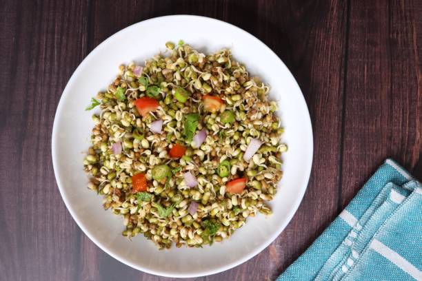 istock Sprouted moong beans. Protine rich salad. Healthy snack items. Sprouted Lentil Salad. Mixed with Onion, tomatoes, green chili and coriander. Copy space. Sprout Bhel. 1677867426