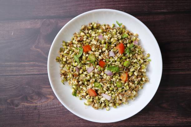 istock Sprouted moong beans. Protine rich salad. Healthy snack items. Sprouted Lentil Salad. Mixed with Onion, tomatoes, green chili and coriander. Copy space. Sprout Bhel. 1677867429
