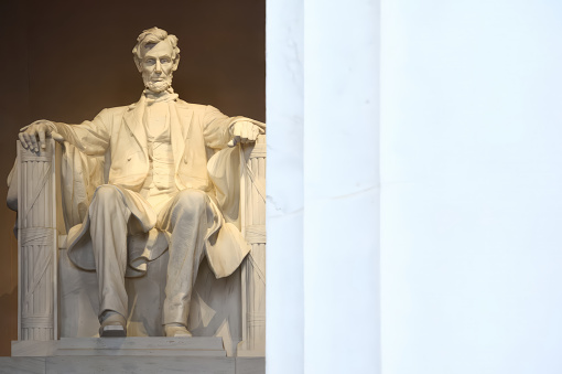 The statue of Abraham Lincoln at the Lincoln Memorial in Washington D.C. with a white text copy space