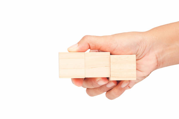 istock Empty wooden cubes in a hand with a white background 1677910085