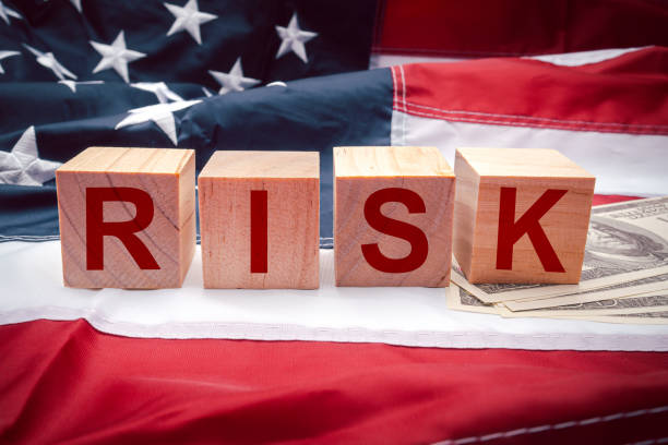 istock Wooden cubes with text RISK on the American flag. Risk management concept 1677917849