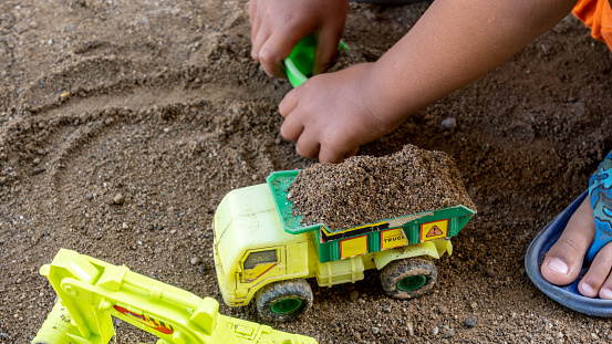 toys for boys in the form of sand trucks and excavator cars