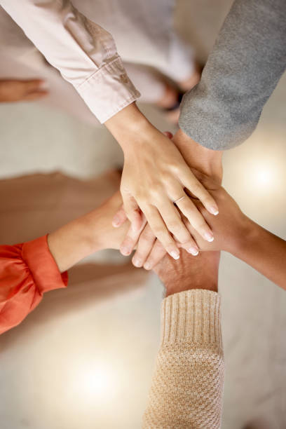 istock Team building, top view or hands in meeting together on a business or group project for motivation. Diversity, mission or employees in collaboration for our vision, strategy planning or target goals 1677947310
