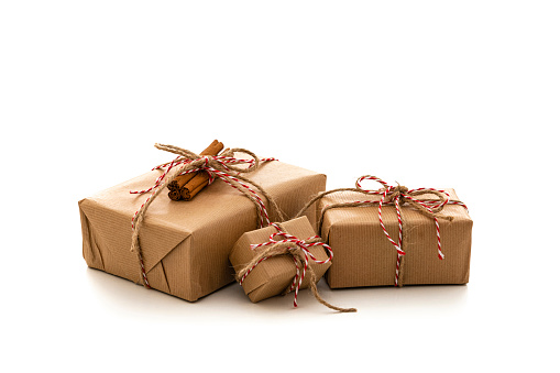 Christmas gift boxes wrapped with brown paper isolated on white background