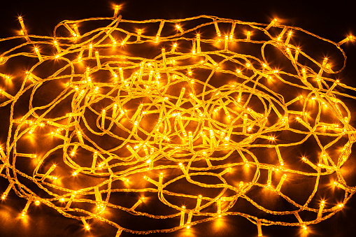Tangled illuminated  LED Christmas string ligts on dark background