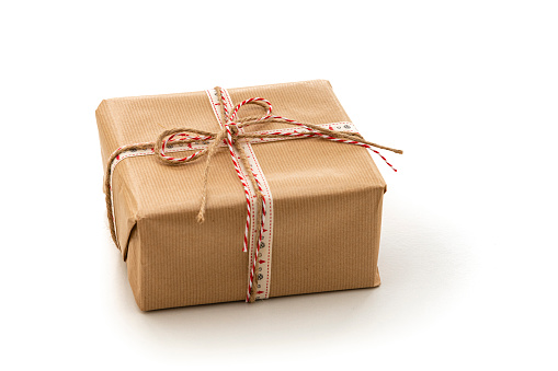 Christmas gift box wrapped with brown paper isolated on white background