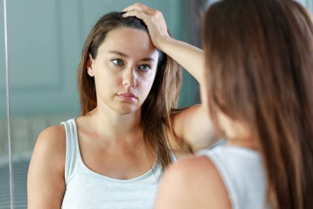 istock Upset woman standing front on mirror and thinking of her problems and depression 1677954445