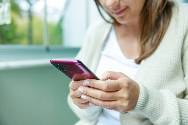 istock Young woman using phone at home 1677960655