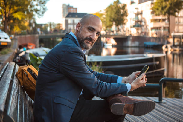 istock Handsome elegant single gay male 50s working man in Amsterdam 1677964052