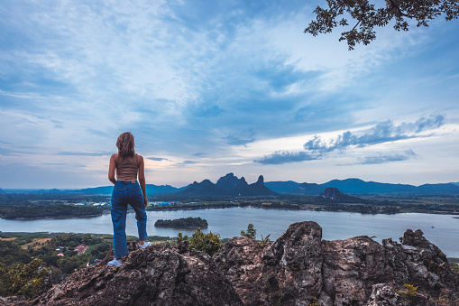 Happy Traveler asian woman travel in Phu Sub Lek Reservoir viewpoint, Lopburi, Thailand, Landscape view of mountain and lake background