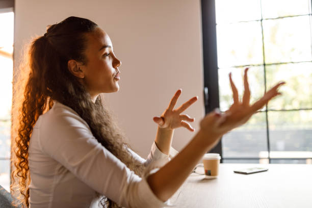 istock Charming young woman gesturing while talking via video call 1677968428