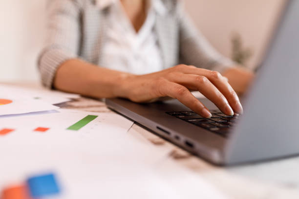 istock Young woman typing data on laptop keyboard 1677973301