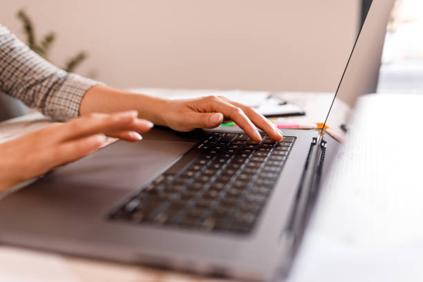 istock Young woman typing data on laptop keyboard 1677973302