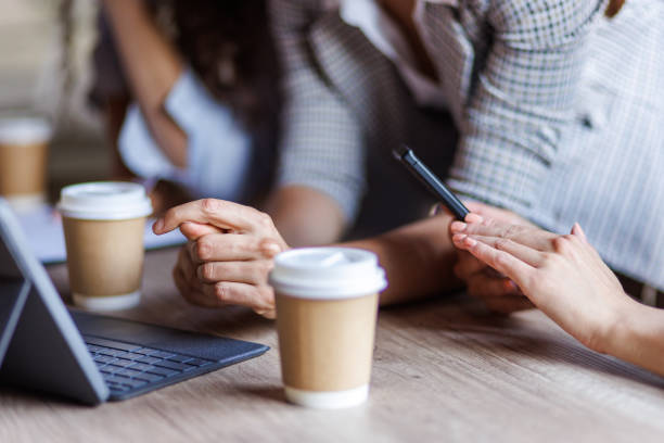 istock Businesswomen discussing project plans during a briefing with coffee 1677979333