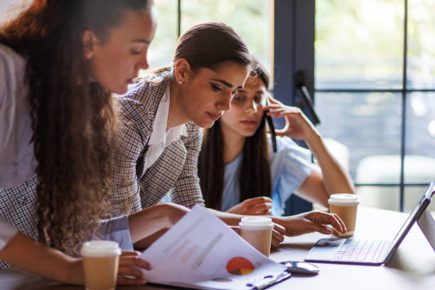 istock Businesswomen discussing project plans during a briefing with coffee 1677979339