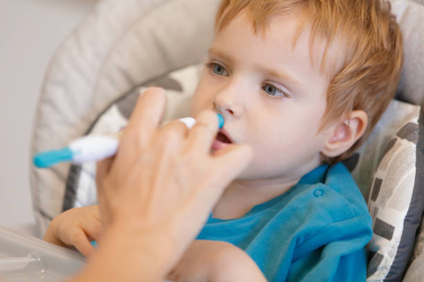 istock Doctor using special aid in feeding therapy and stimulating little blond boy's mouth 1677990672