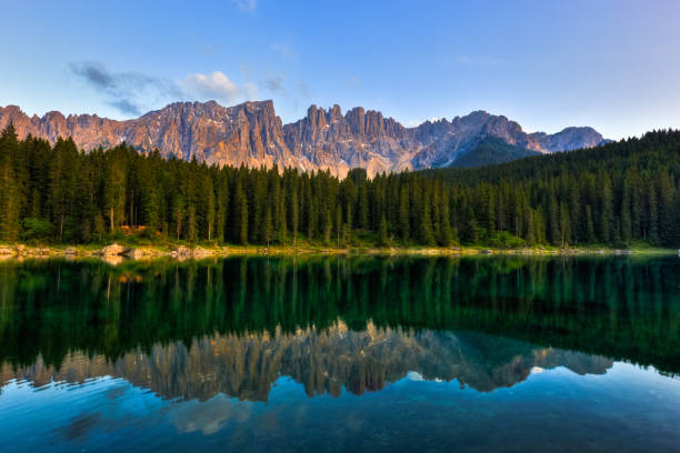 Alpine Lake Reflection at Sunset, Dolomites, Italy. HDR image. Location: Carezza Lake, South Tyrol, Italy.