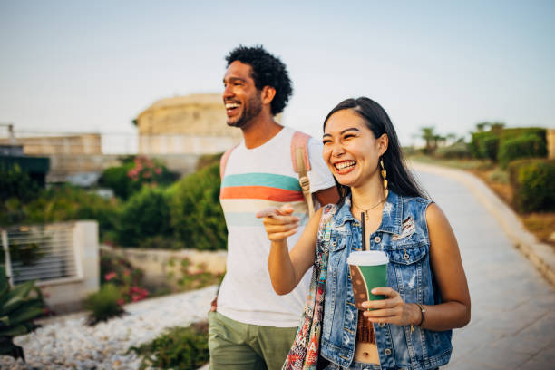 istock A smiling Taiwanese woman points her finger at something in front of her while walking with her black friend 1678023174