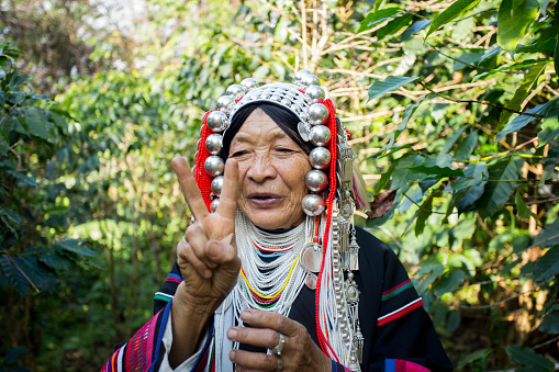 Chiang Mai, Thailand; 1st January 2023: Elderly woman from the indigenous Akha tribe of northern Thailand on an organic coffee plantation..