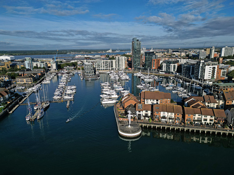 Aerial view of Ocean Village Marina in Southampton. A residential area with harbor.  Sailing boats and yachts securely moored.