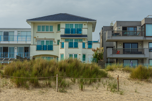 Poole, UK - September 9th 2023: Houses on the seafront overlooking dunes and sand on Sandbanks Beach.