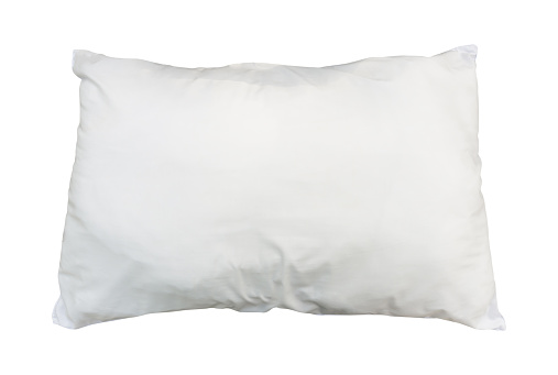 White pillow in hotel or resort room is isolated on white background with clipping path. Concept of confortable and happy sleep in daily life