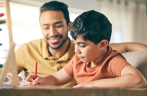 Father help child, homework and education, writing and learning with studying, activity and development. Family, teaching and support for school with knowledge, man and boy in living room with growth