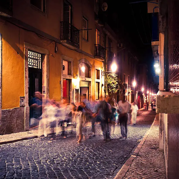 People walking by Night in Barrio Alto of Lisbon, Portugal