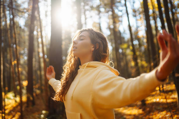 istock Young woman performs yoga exercises in the autumn forest. 1678079669
