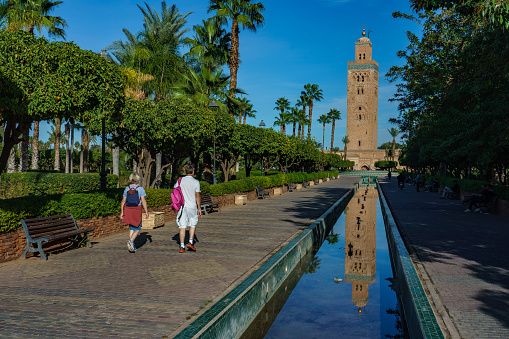 North Africa. Morocco. Marrakesh. The minaret of the Koutoubia mosque with gardens and canals.