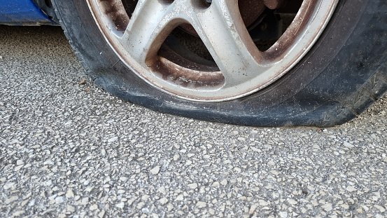 flat car tire roed ascphalt assistance old broken