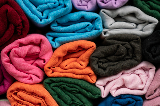 close up of rolled colorful clothes, texture and background