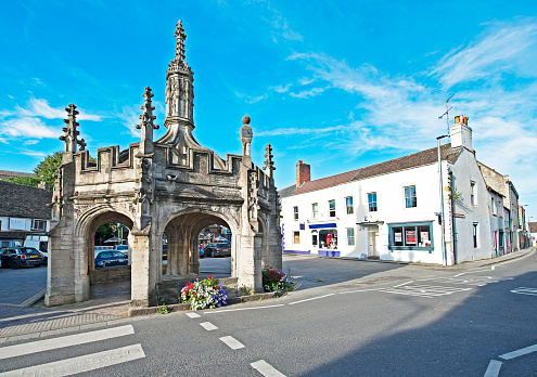 Market Cross, Malmesbury hilltop town centre, Wiltshire, England. On a hilltop site, Malmesbury was once marked by an iron age fort and later became one of the most significant towns in England,. Situated on the River Avon, it features the Abbey, now over one thousand years old and other quaint and distinctive architecture that maps the centuries.