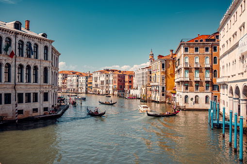 breathtaking beauty of Venice, Italy with an amazing view of the city. Delight in the enchanting sight of numerous gondolas gracefully sailing down one of the picturesque canals.