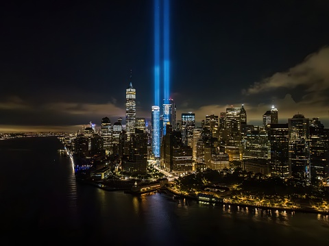 An aerial view of the Tribute in Light from the National September 11 Memorial and Museum in New York City at night. The twin beams reach up to 4 miles into the sky as a commemorative public art installation on display from dusk to dawn.
