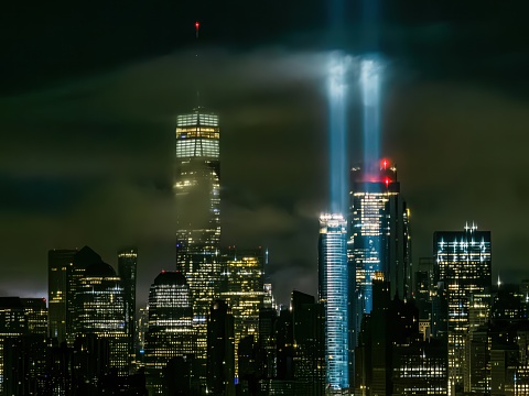 An aerial view of the Tribute in Light from the National September 11 Memorial and Museum in New York City at night. The twin beams reach up to 4 miles into the sky as a commemorative public art installation on display from dusk to dawn.