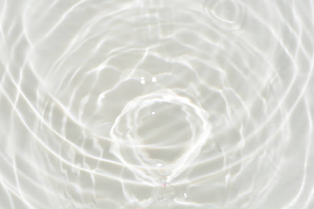 istock White water with ripples on the surface. Defocus blurred transparent white colored clear calm water surface texture with splashes and bubbles. Water waves with shining pattern texture background. 1678145898