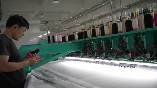 Male worker working in knitting factory