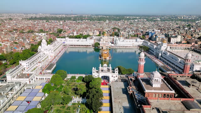 Amritsar, India: Aerial view of famous city in Punjab, iconic hisrorical landmark The Golden Temple (Harimandir Sahib) - landscape panorama of South Asia from above